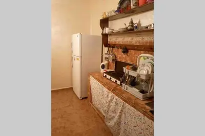 a kitchen with a stove and a refrigerator at Nice 2 Bedrooms Apartment near the beach in Rabat