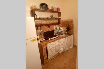 a kitchen with a stove and a refrigerator at Nice 2 Bedrooms Apartment near the beach in Rabat