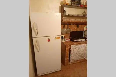 a white refrigerator in a kitchen next to a counter at Nice 2 Bedrooms Apartment near the beach in Rabat