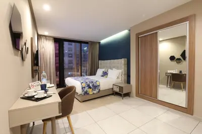 a hotel room with a bed and a desk and a room at Address Hotel Casablanca in Casablanca