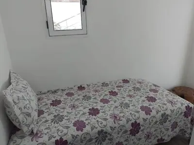 a couch with a blanket on it with a window at La Grande Proprit toile De Mer in Skhirat