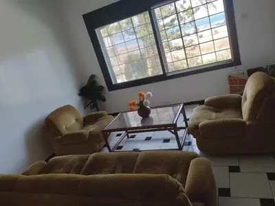 a living room with two couches and a coffee table at La Grande Proprit toile De Mer in Skhirat