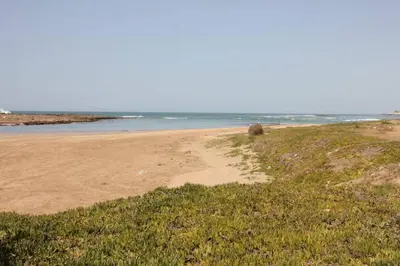 a sandy beach with the ocean in the background at Maison Etoile De Mer 2 in Skhirat