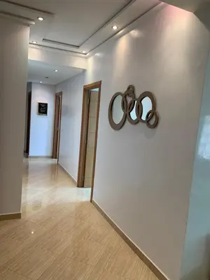 a hallway with two olympic rings on a wall at A 5 minutes à pied de la plage un bel appartement à saisir in Sidi Rahal