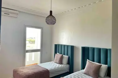 a bedroom with two beds and a window at Appartement vue mer panoramique in Tamaris