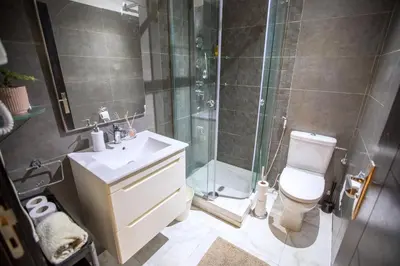 a bathroom with a shower and a toilet and a sink at Appartement chic en plein Gauthier in Casablanca