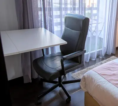 a desk with a chair next to a bed at Appartement chic en plein Gauthier in Casablanca
