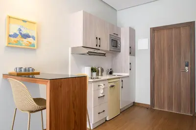 a small kitchen with a counter and a table at BH Appart Hotel in Casablanca