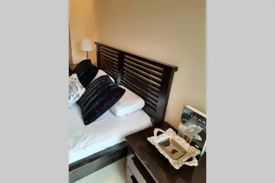 a bedroom with a bed and a desk with a telephone at CASABAY Sidi Rahal, appartement avec accés direct à la plage et piscine in Sidi Rahal