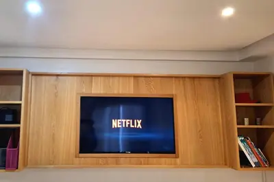 a flat screen tv sitting inside of a entertainment center at Grand appartement de luxe vue mer in Casablanca