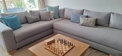 a living room with a couch with a chessboard on it at Grand appartement de luxe vue mer in Casablanca