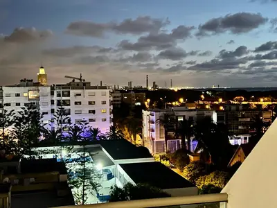 a view of a city at night with buildings at OceanParc - Vue sur Mer et Parc 24H Sécurité in Mohammedia