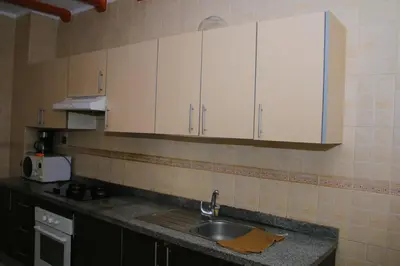 a kitchen with a sink and white cabinets at Mohammedia vive les vacances in Mohammedia