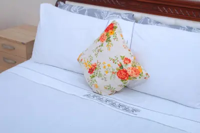a pillow sitting on top of a bed at BOUZNIKA Appartement 4 in Bouznika