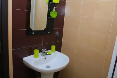 a bathroom with a sink and a mirror at Appartement au centre ville in Bouznika
