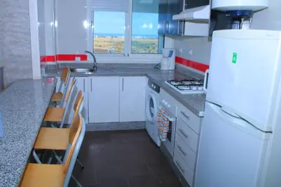 a kitchen with white appliances and a white refrigerator at BOUZNIKA au centre in Bouznika
