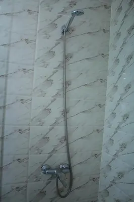 a shower with a shower head in a bathroom at BOUZNIKA au centre in Bouznika
