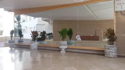 a lobby with a counter with potted plants on it at Elegant Appartement in Bouznika in Bouznika