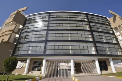 a large glass building with a lot of windows at BOUZNIKA Appartement avec piscine in Bouznika