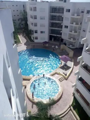 a large swimming pool in the middle of a building at BOUZNIKA Piscine et plage in Bouznika