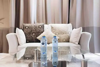 two water bottles on a glass table in front of a couch at STUDIO HAUT STANDING A RACINE near twin center in Casablanca