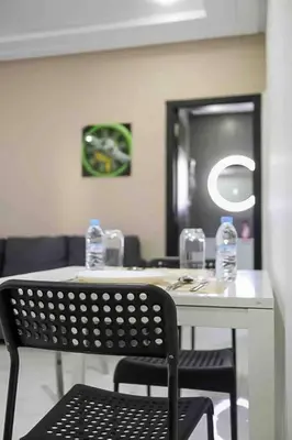 a room with a table with a chair and a mirror at Gauthier studio in Casablanca