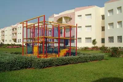 a play structure in front of a building at La résidence des vagues in Mohammedia