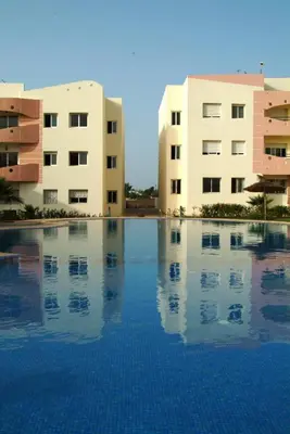 a swimming pool in front of two buildings at La Perle de la Côte Atlantique in Mohammedia