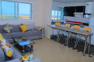 a living room with a couch and a table at BOUZNIKA T1 in Bouznika