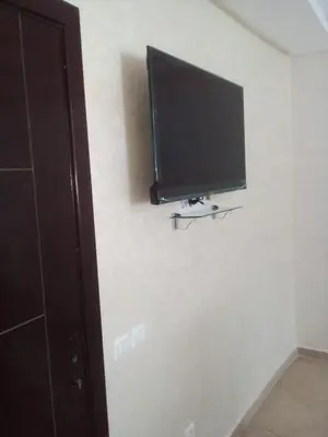 a flat screen tv hanging on a wall at Le Petit Havre de Joie BOUZNIKA in Bouznika