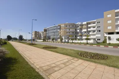 an empty street with buildings on the side of a road at BOUZNIKA T10 in Bouznika