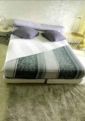 a bed with two pillows on it in a room at Appartement RIM in Casablanca