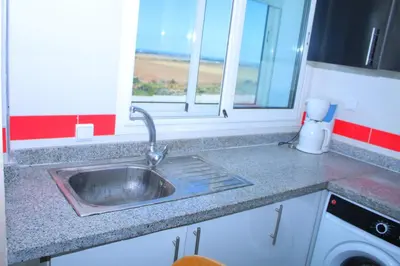 a kitchen counter with a sink and a window at BOUZNIKA Z2 in Bouznika