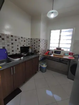 a kitchen with a sink and a microwave at Spacious 2BR Ground-Floor Apartment Parking & Free Wi-Fi in Casablanca