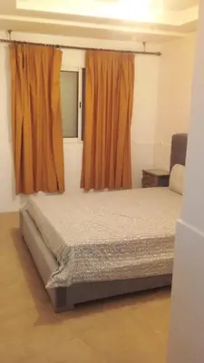 a bedroom with a bed and a window at Appartement 2 chambres Bouznika in Bouznika