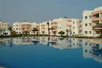 a large pool in front of some apartment buildings at MOHAMMEDIA Appartement avec 3 piscines et prés de plage in Mohammedia