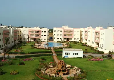 a large building with a courtyard with a fountain at Elégant appartement in MOHAMMEDIA in Mohammedia