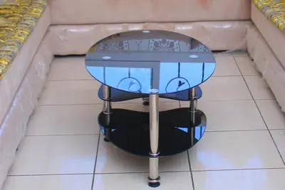 a glass table sitting on top of a tile floor at Magnifique Appartement MOHAMMEDIA in Mohammedia