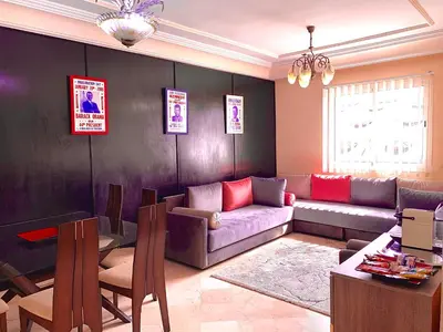 a living room with a couch and a table at Sab 8 - Amazing view. 2 bedrooms in front of the mosque Hassan. Perfect location in Casablanca