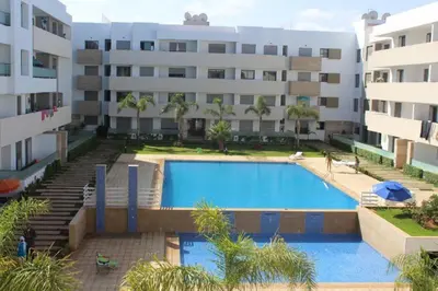 a swimming pool in front of a building at MOHAMMEDIA Paradise Beach in Mohammedia
