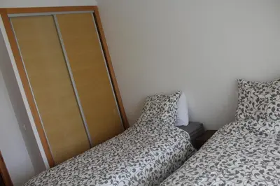 a bedroom with two beds next to a closet at Paradise BEACH in Mohammedia