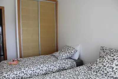a bedroom with a bed and a pillow next to a closet at Paradise BEACH in Mohammedia