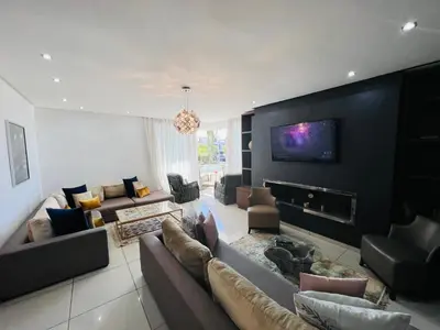 a living room with couches and a tv on a wall at Melrose Beαch Aρραrt Pοοl Vieω in Casablanca