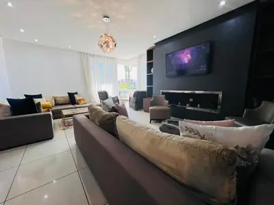 a living room with a couch and a fireplace at Melrose Beαch Aρραrt Pοοl Vieω in Casablanca