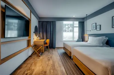 a hotel room with two beds and a television at Hilton Garden Inn Casablanca Sud in Casablanca