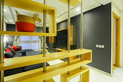 a room with wooden shelves and a living room at Racine spacious 2 bedrooms near twin center#Freewifi#freeparking in Casablanca