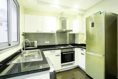 a kitchen with a stainless steel refrigerator and a sink at Racine spacious 2 bedrooms near twin center#Freewifi#freeparking in Casablanca