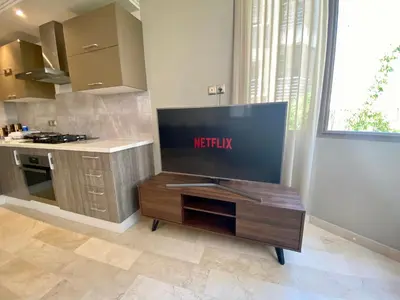 a kitchen with a large tv on a table at #26 Maarif urban Massira near twin center casablanca in Casablanca