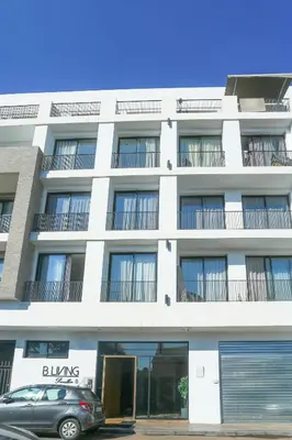 a white building with a car parked in front of it at Lavish Flat in new city #fastwifi#Parking in Casablanca