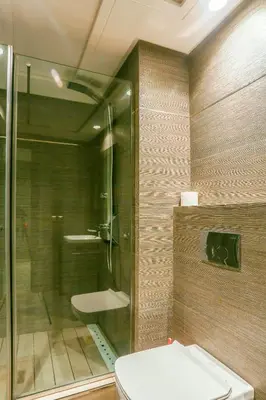 a bathroom with a toilet and a glass shower at Royal Massira flat in shopping center#wifi#parking in Casablanca